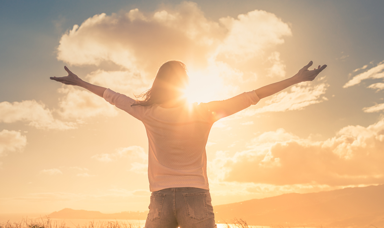 Person embracing sunlight with open arms – symbol of legal gender recognition and personal freedom through Gender Recognition Certificate services by NotaryPublic24.com