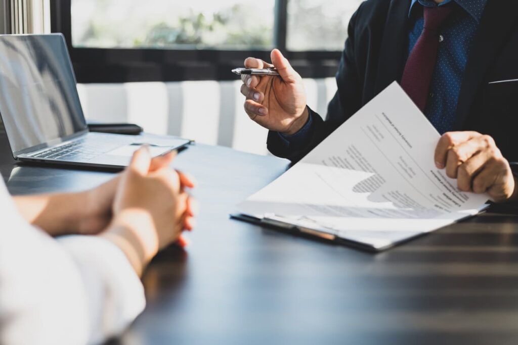 Business meeting reviewing official Companies House document for online certification and Apostille – fast and secure UK document verification process